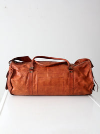 vintage brown leather duffle bag with shoulder strap