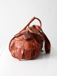 vintage brown leather duffle bag with shoulder strap