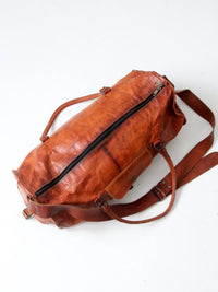 vintage brown leather duffle bag with shoulder strap
