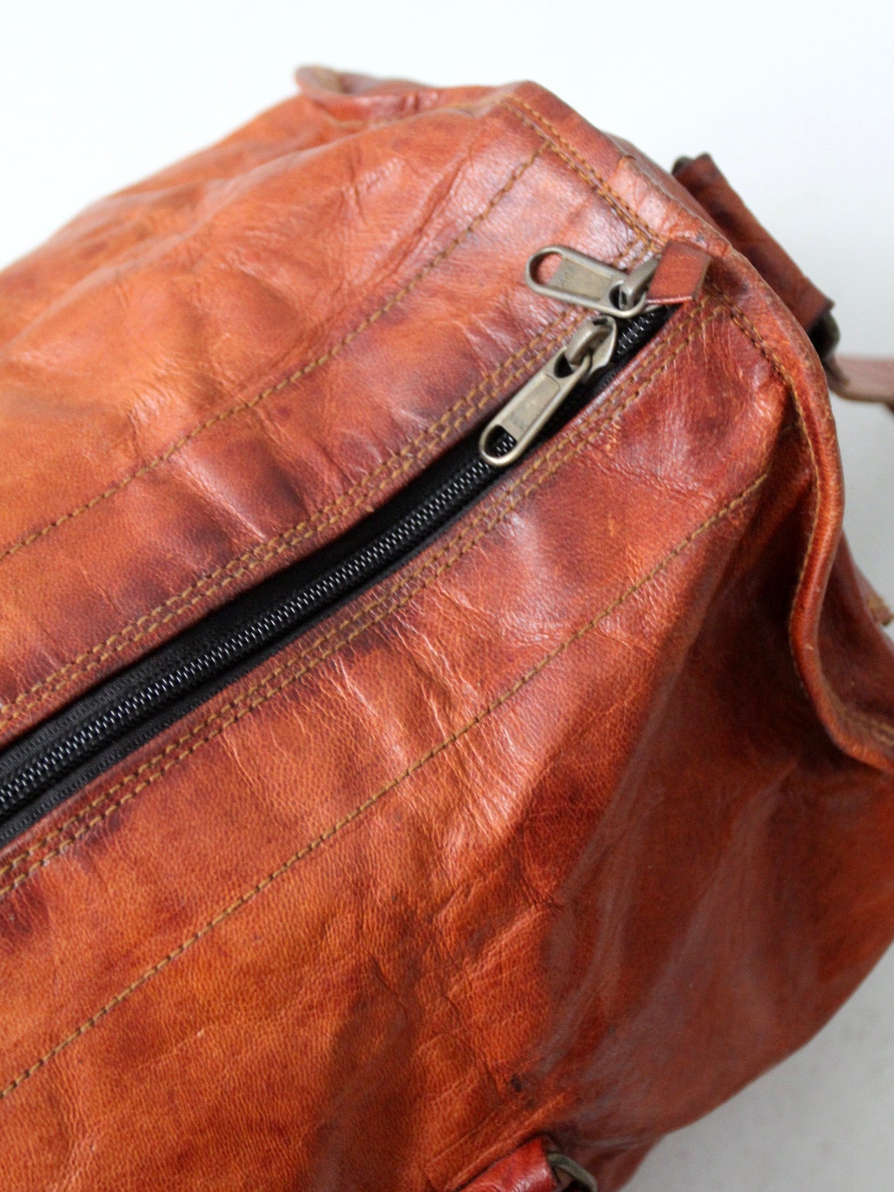 vintage brown leather duffle bag with shoulder strap