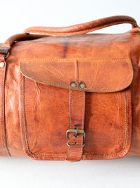 vintage brown leather duffle bag with shoulder strap