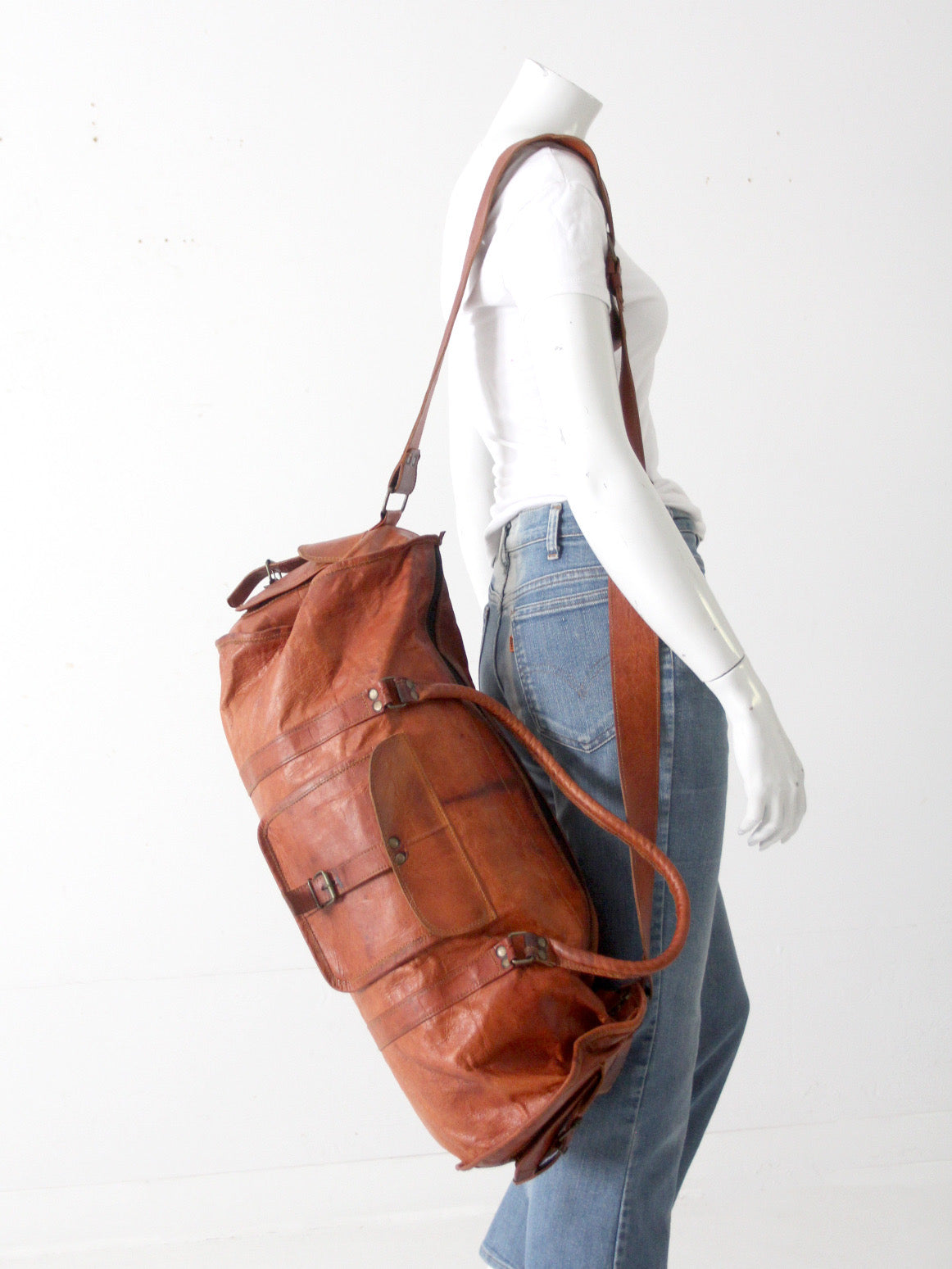 vintage brown leather duffle bag with shoulder strap