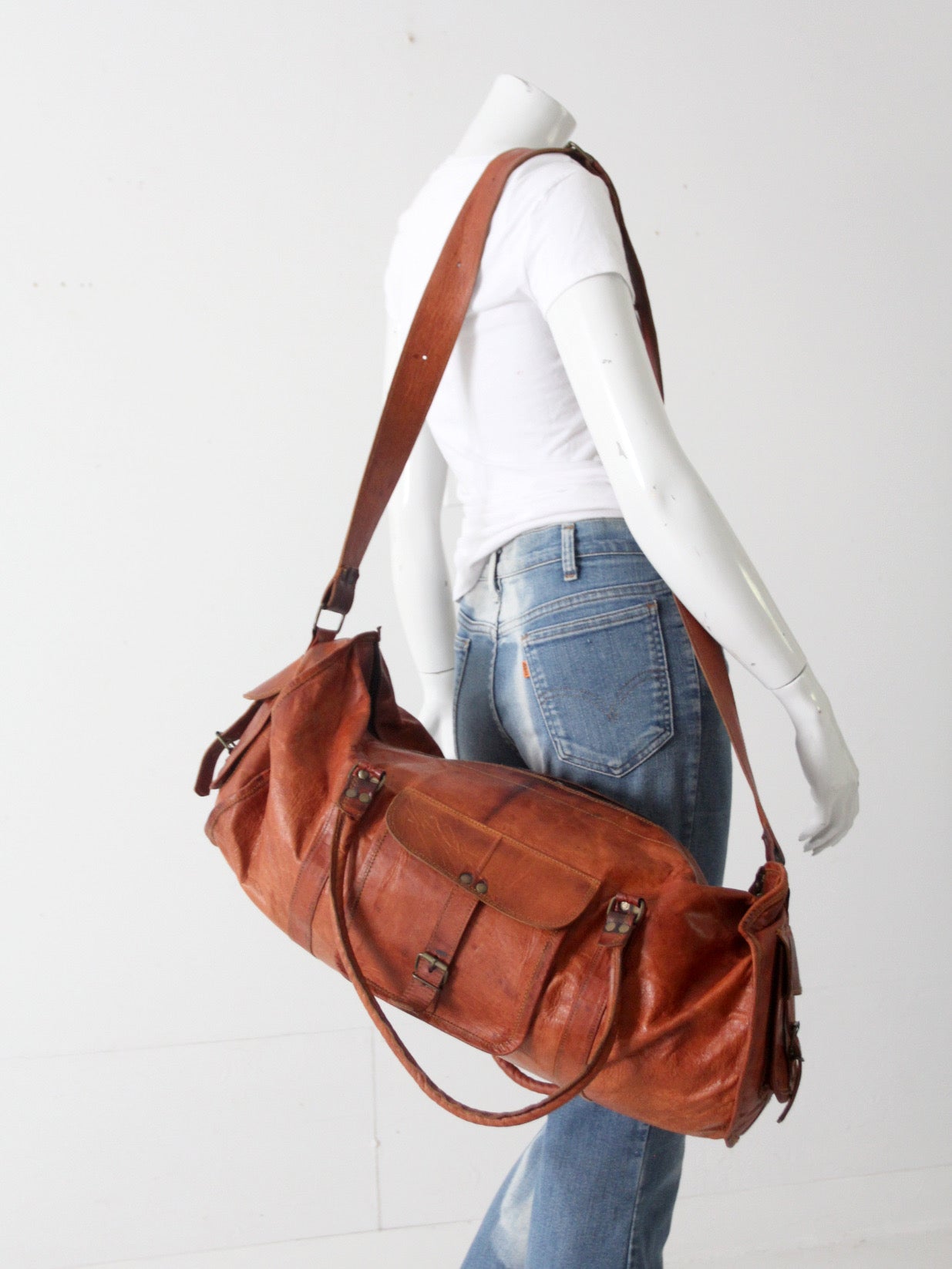 vintage brown leather duffle bag with shoulder strap