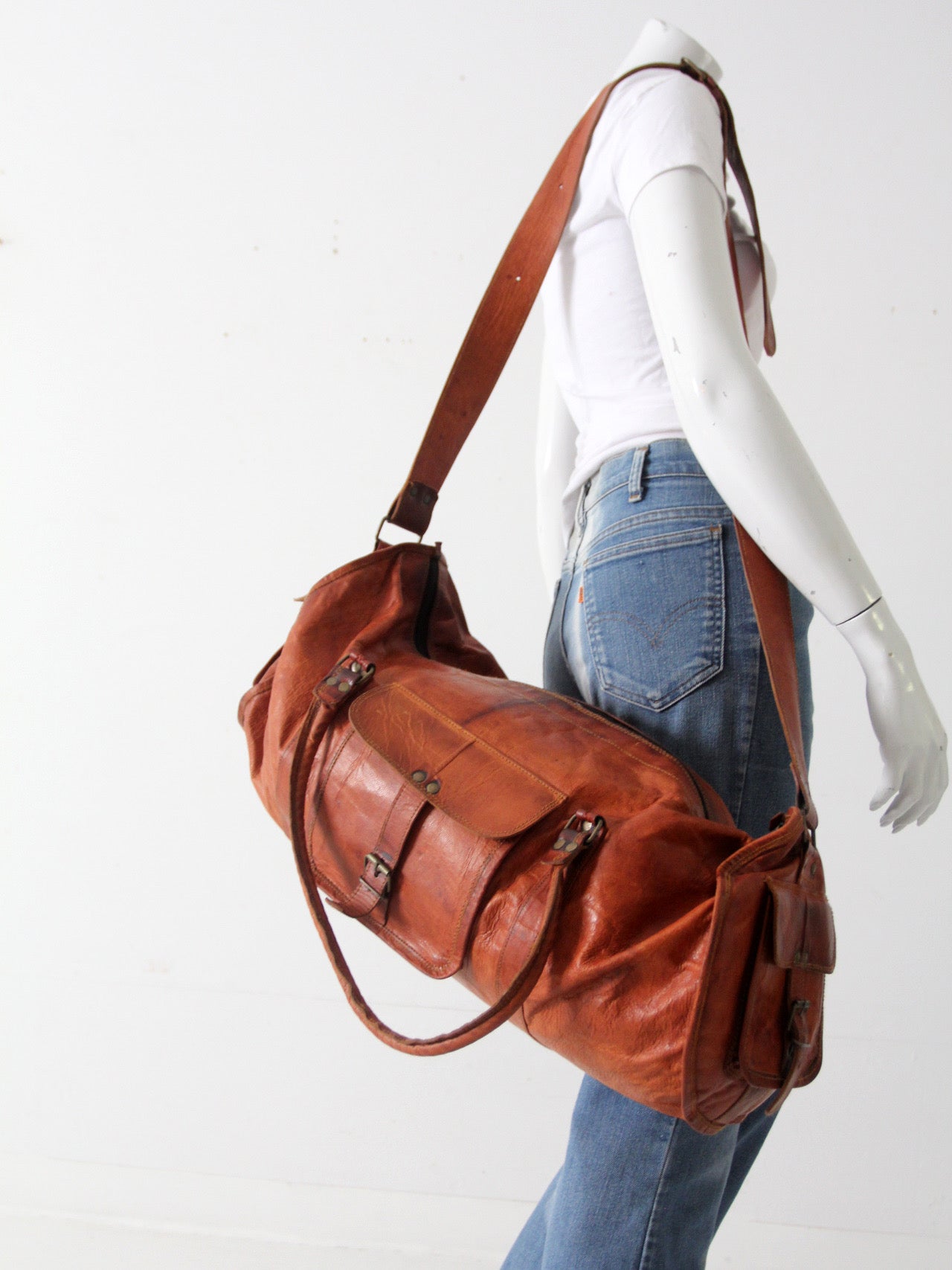 vintage brown leather duffle bag with shoulder strap