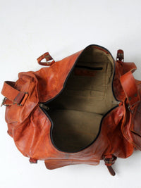 vintage brown leather duffle bag with shoulder strap