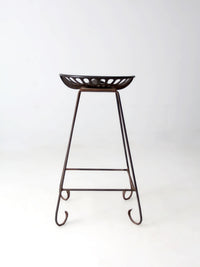 antique Deering tractor seat stool