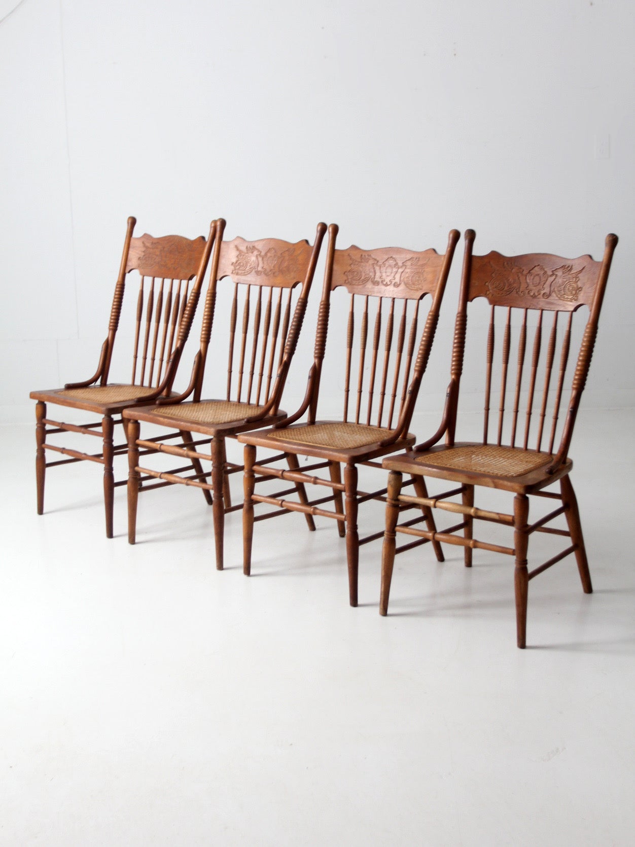antique griffin crest press back dining chairs | set of 4