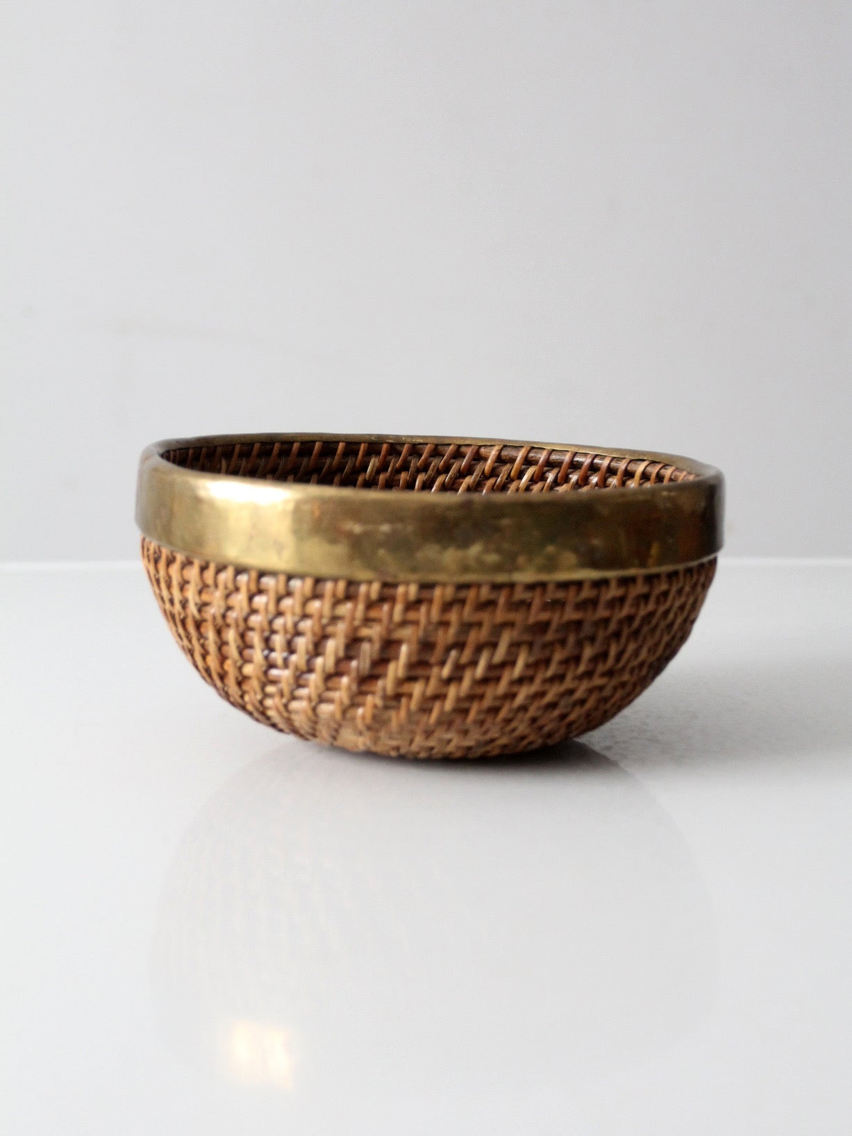 mid-century woven rattan bowl with brass rim
