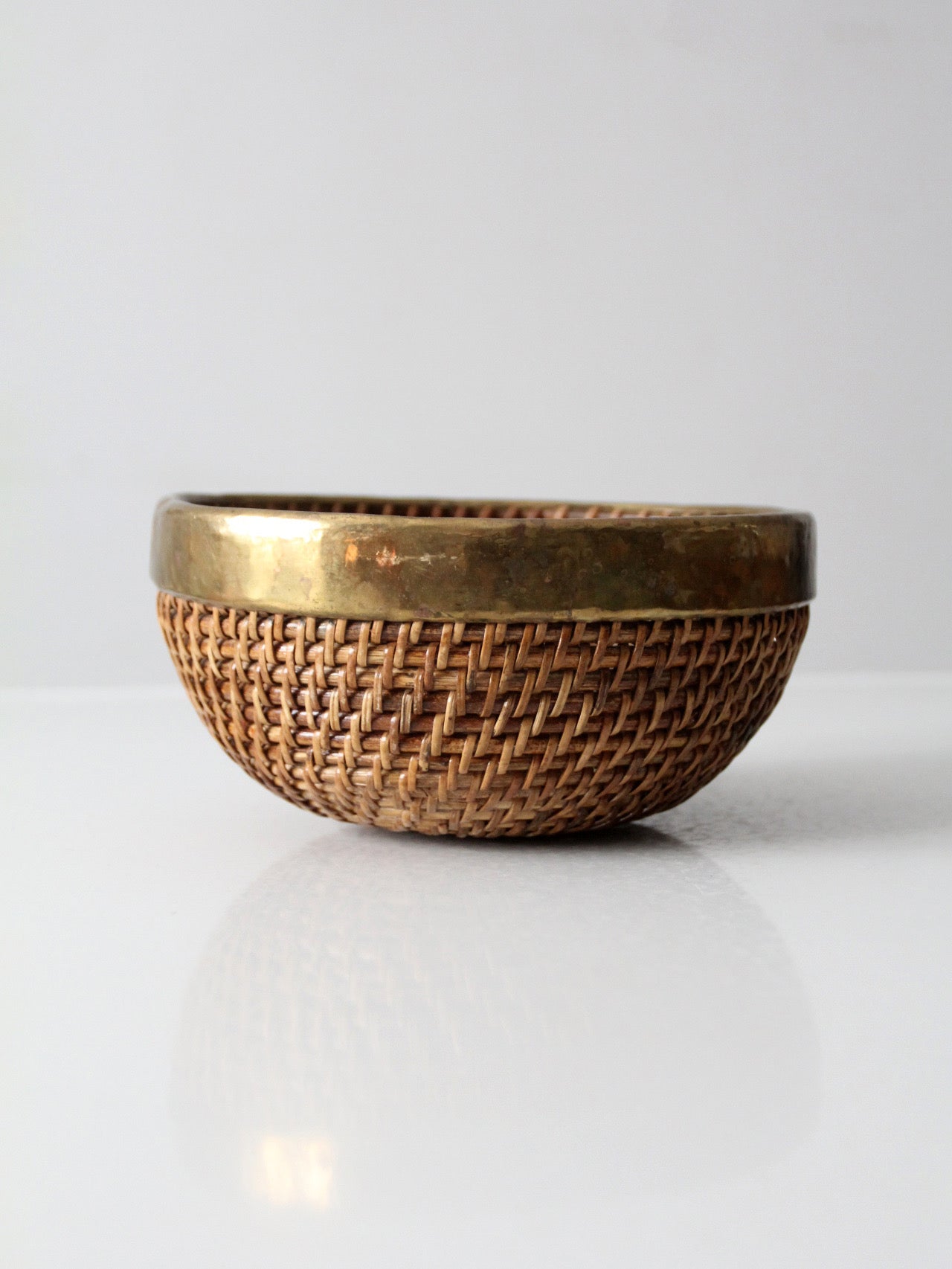 mid-century woven rattan bowl with brass rim