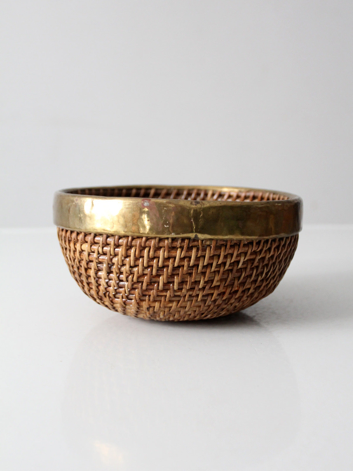 mid-century woven rattan bowl with brass rim