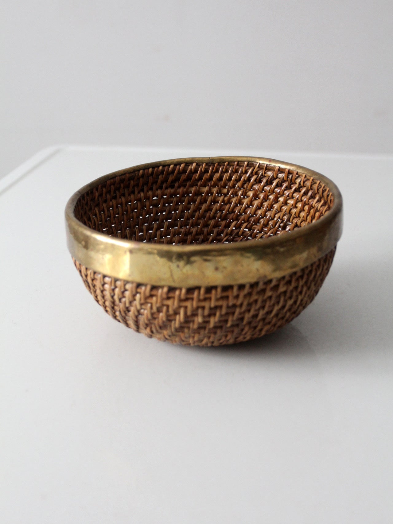 mid-century woven rattan bowl with brass rim