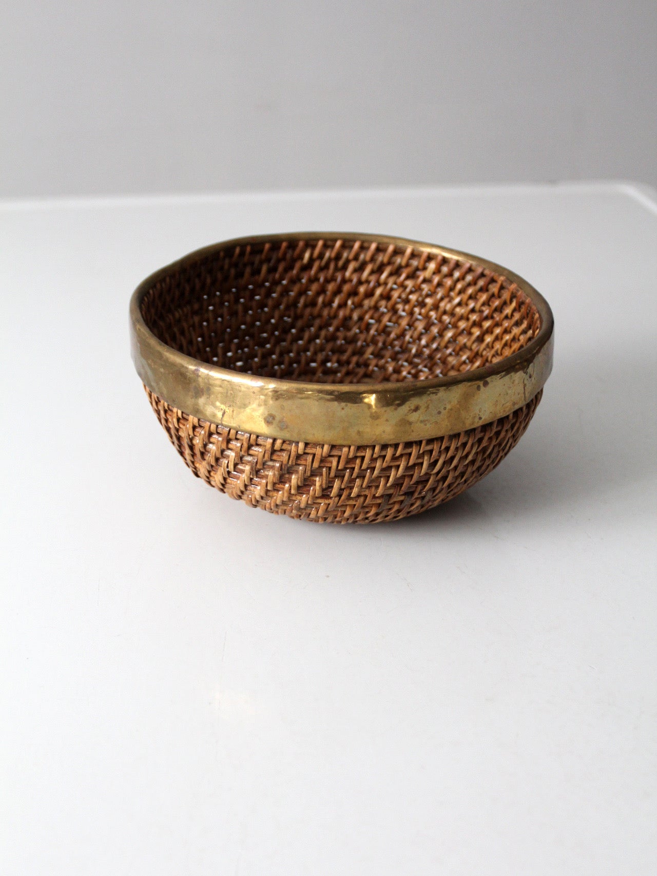 mid-century woven rattan bowl with brass rim