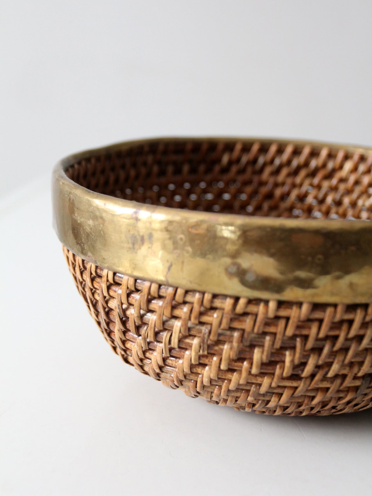 mid-century woven rattan bowl with brass rim