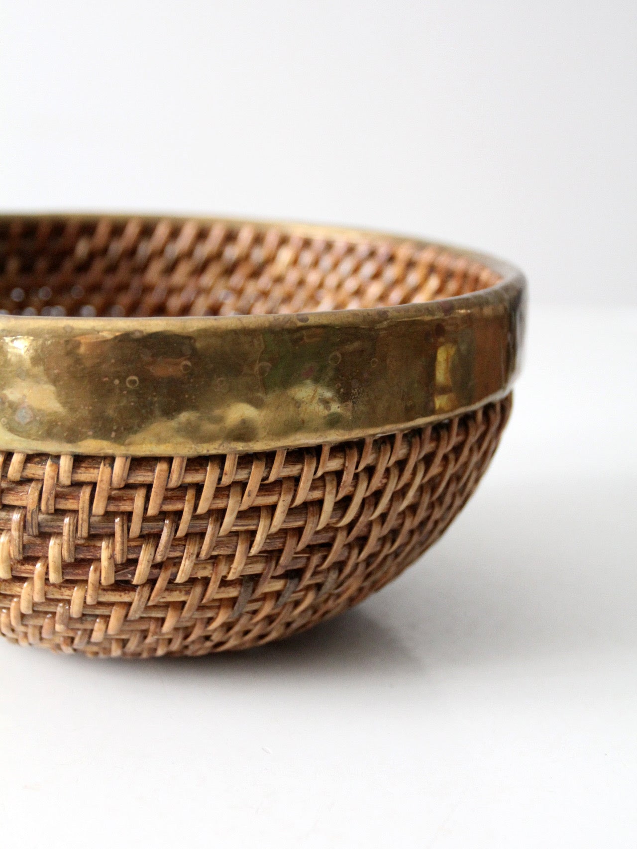 mid-century woven rattan bowl with brass rim