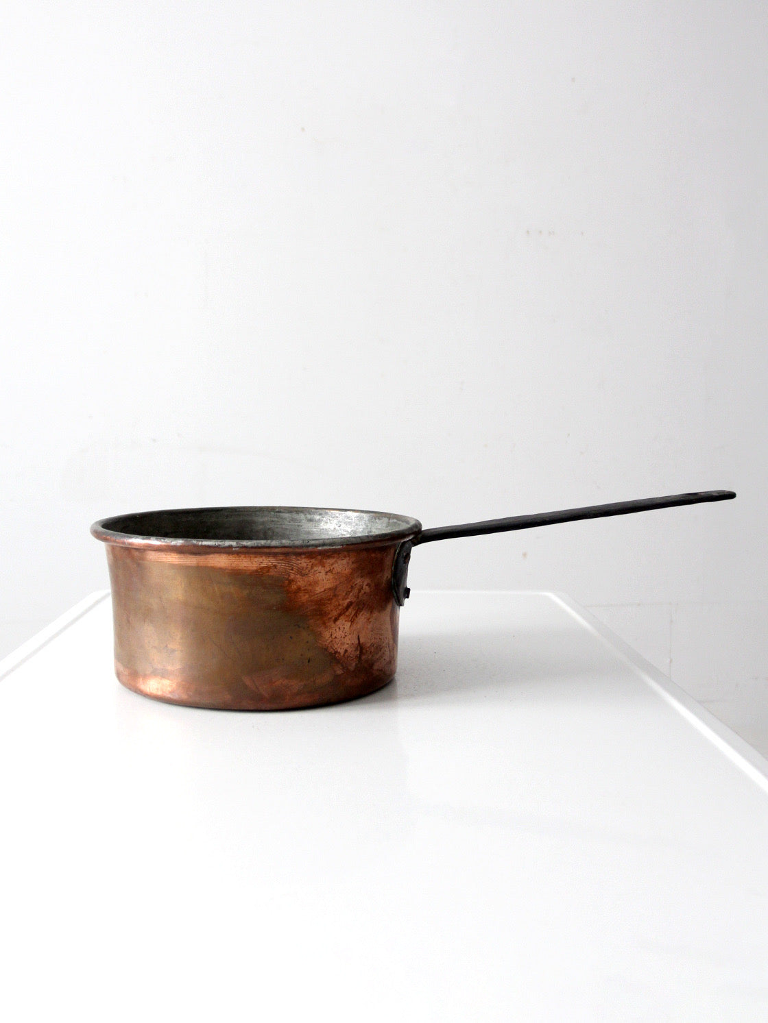 antique copper saucepan with iron handle