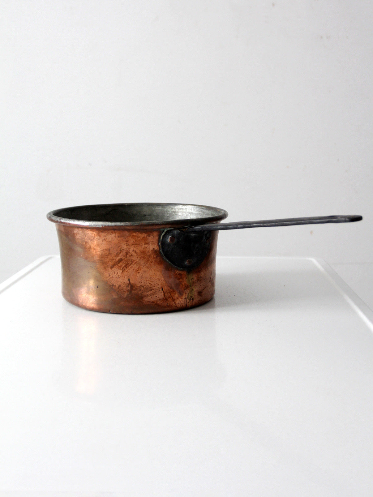 antique copper saucepan with iron handle