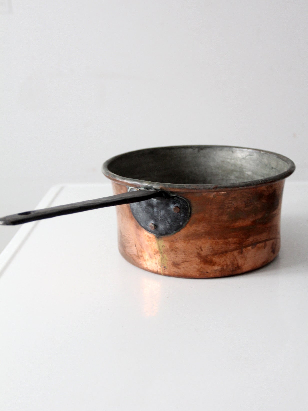antique copper saucepan with iron handle