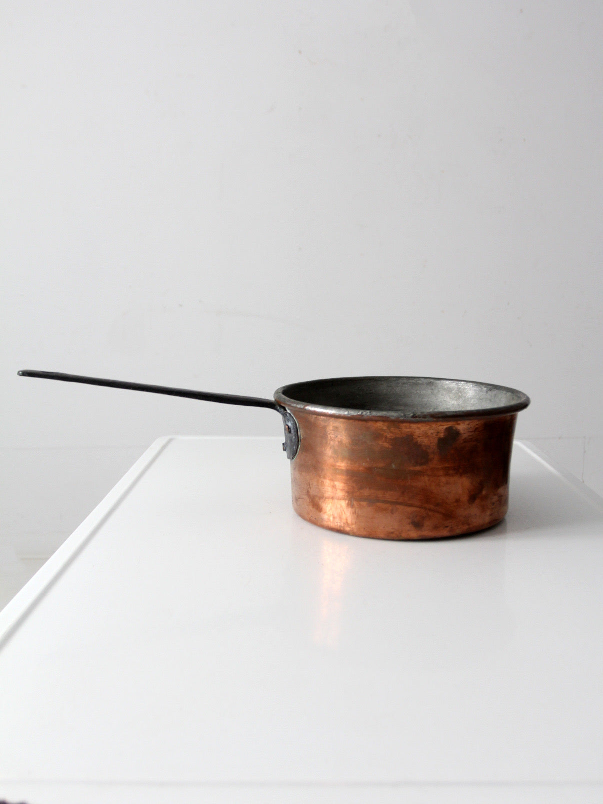antique copper saucepan with iron handle