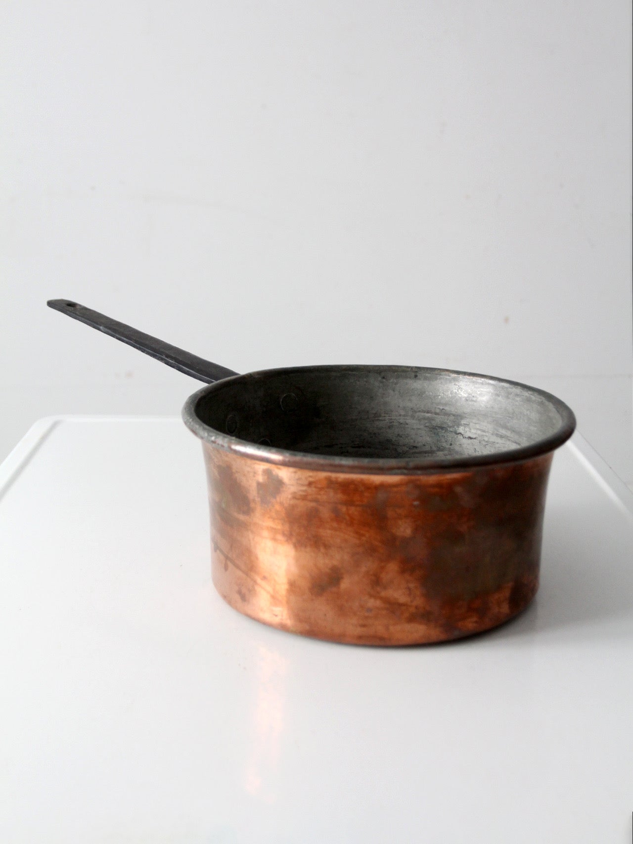 antique copper saucepan with iron handle