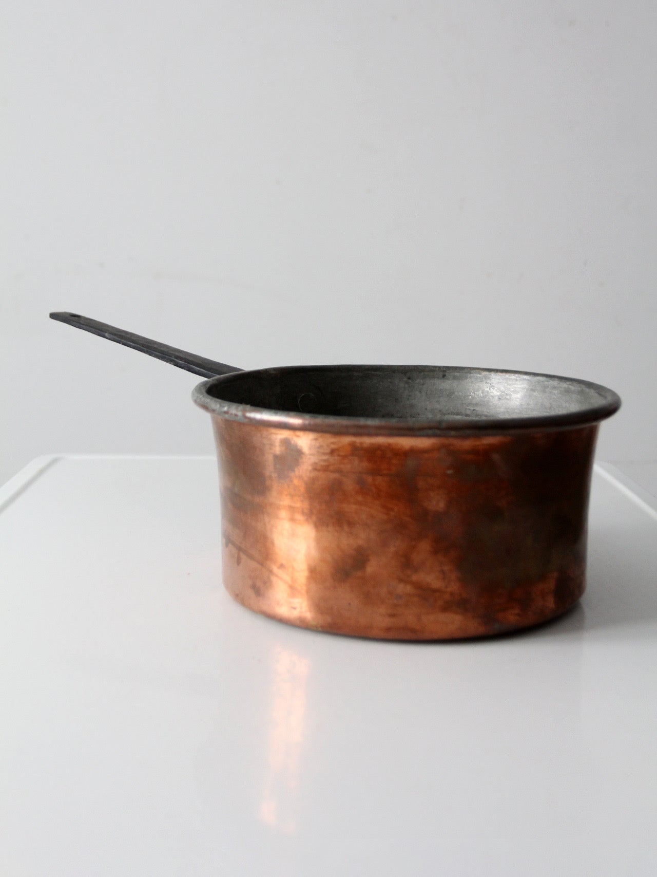 antique copper saucepan with iron handle