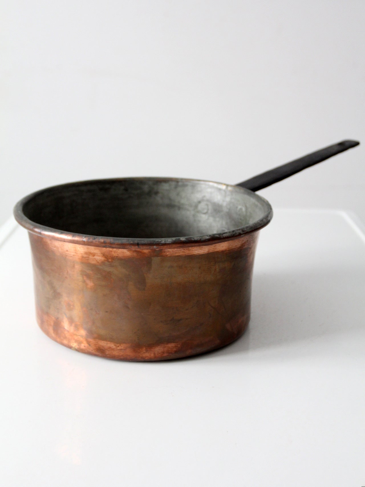antique copper saucepan with iron handle