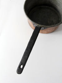 antique copper saucepan with iron handle