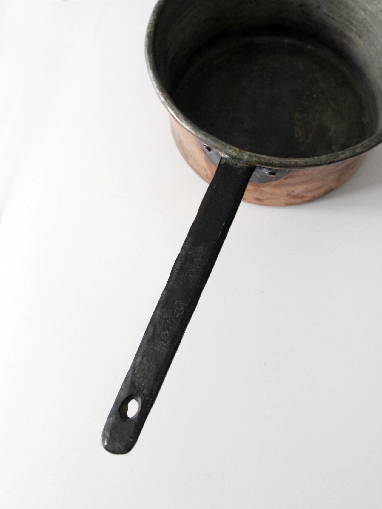 antique copper saucepan with iron handle