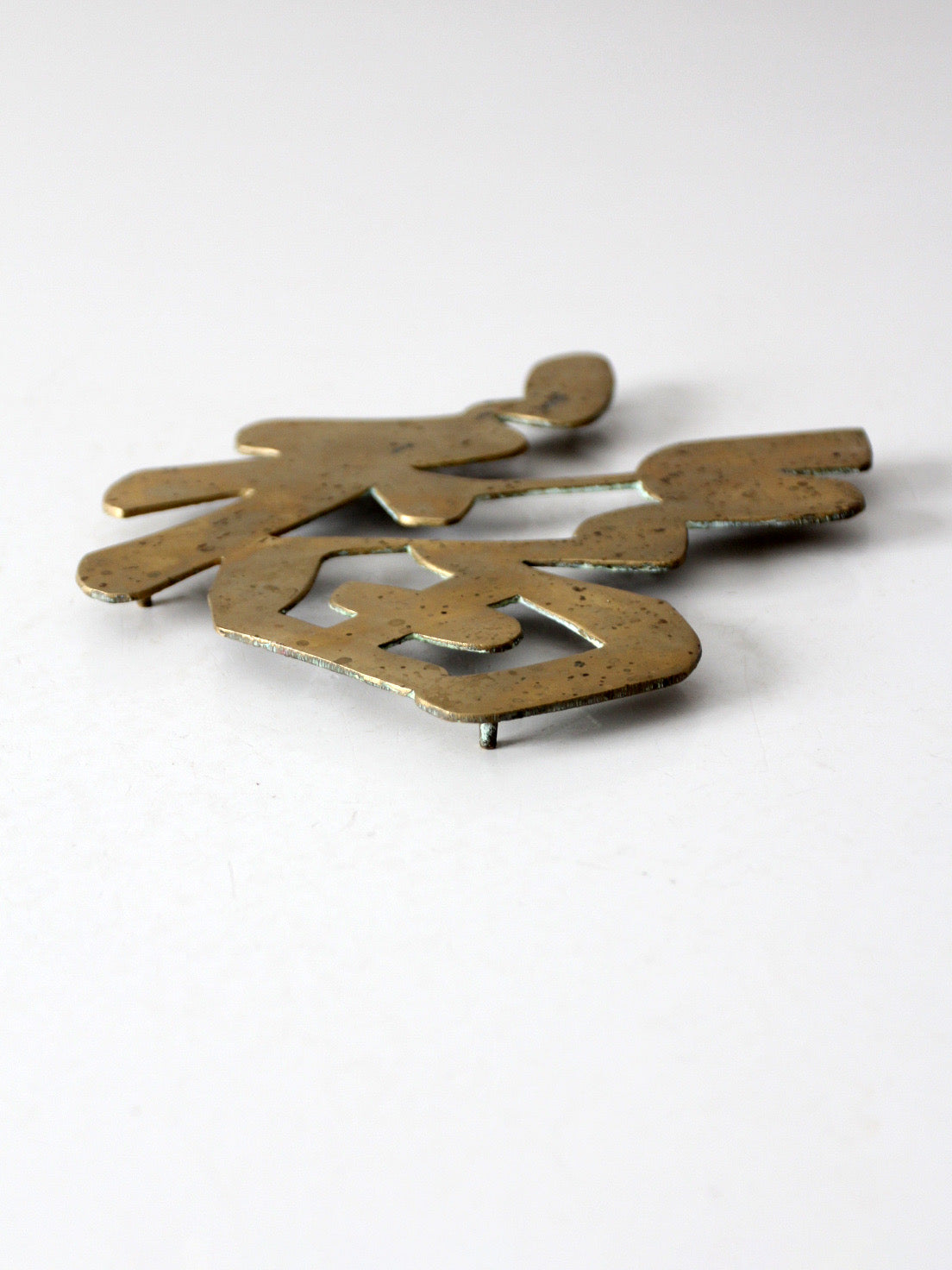 vintage brass good luck symbol trivet