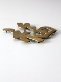 vintage brass good luck symbol trivet