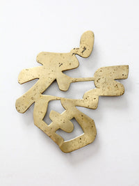 vintage brass good luck symbol trivet