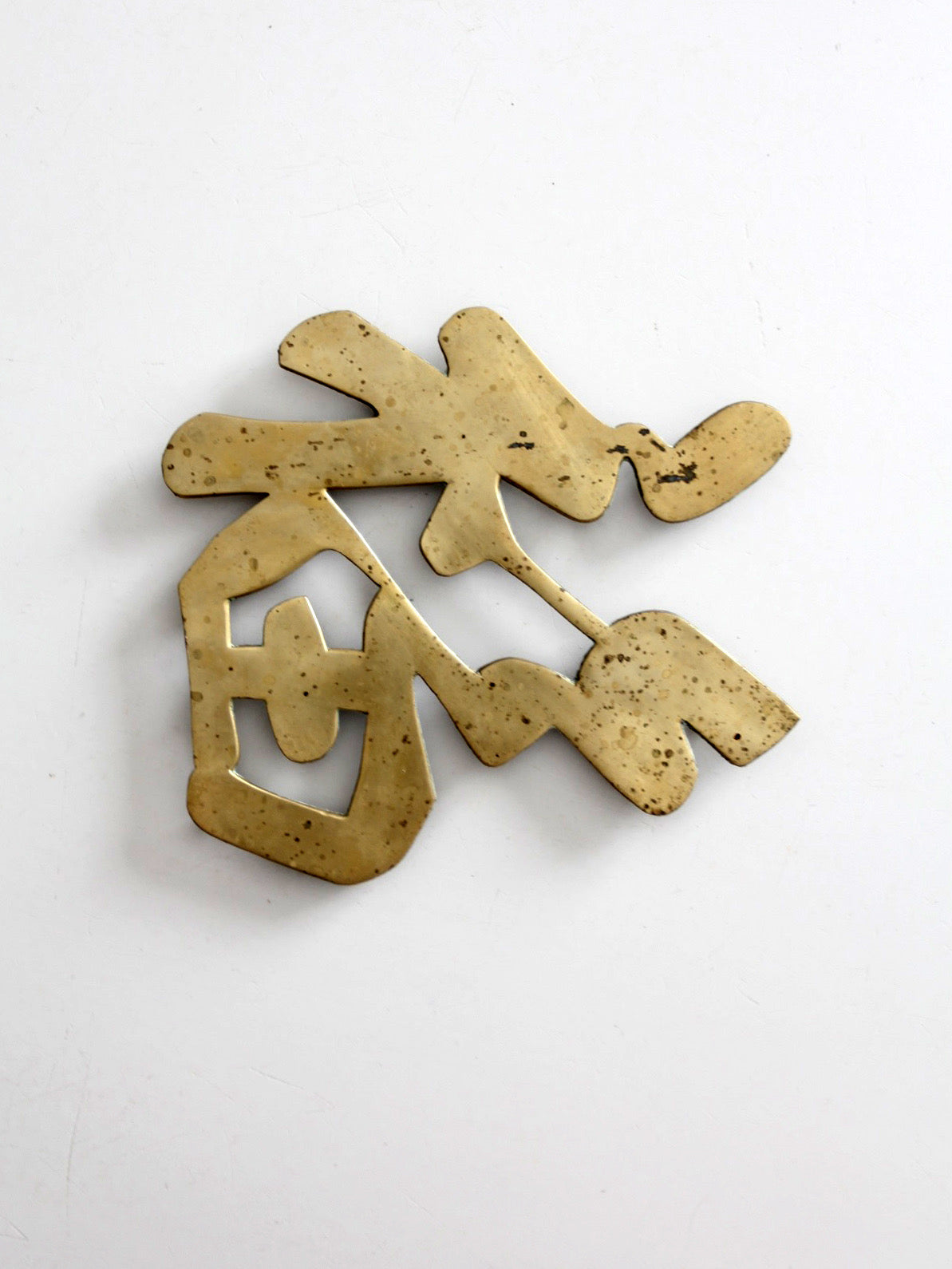vintage brass good luck symbol trivet