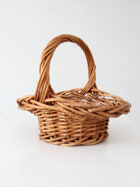 vintage woven wicker gathering basket with twisted handle