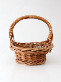 vintage woven wicker gathering basket with twisted handle