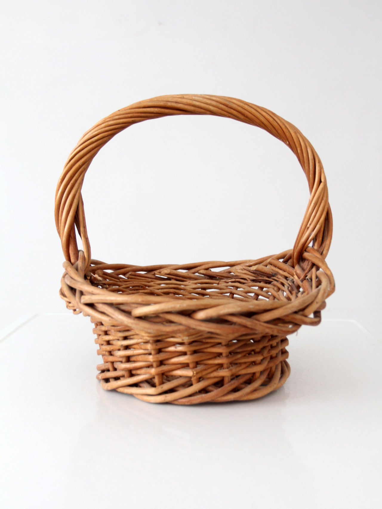 vintage woven wicker gathering basket with twisted handle