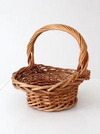 vintage woven wicker gathering basket with twisted handle