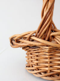 vintage woven wicker gathering basket with twisted handle