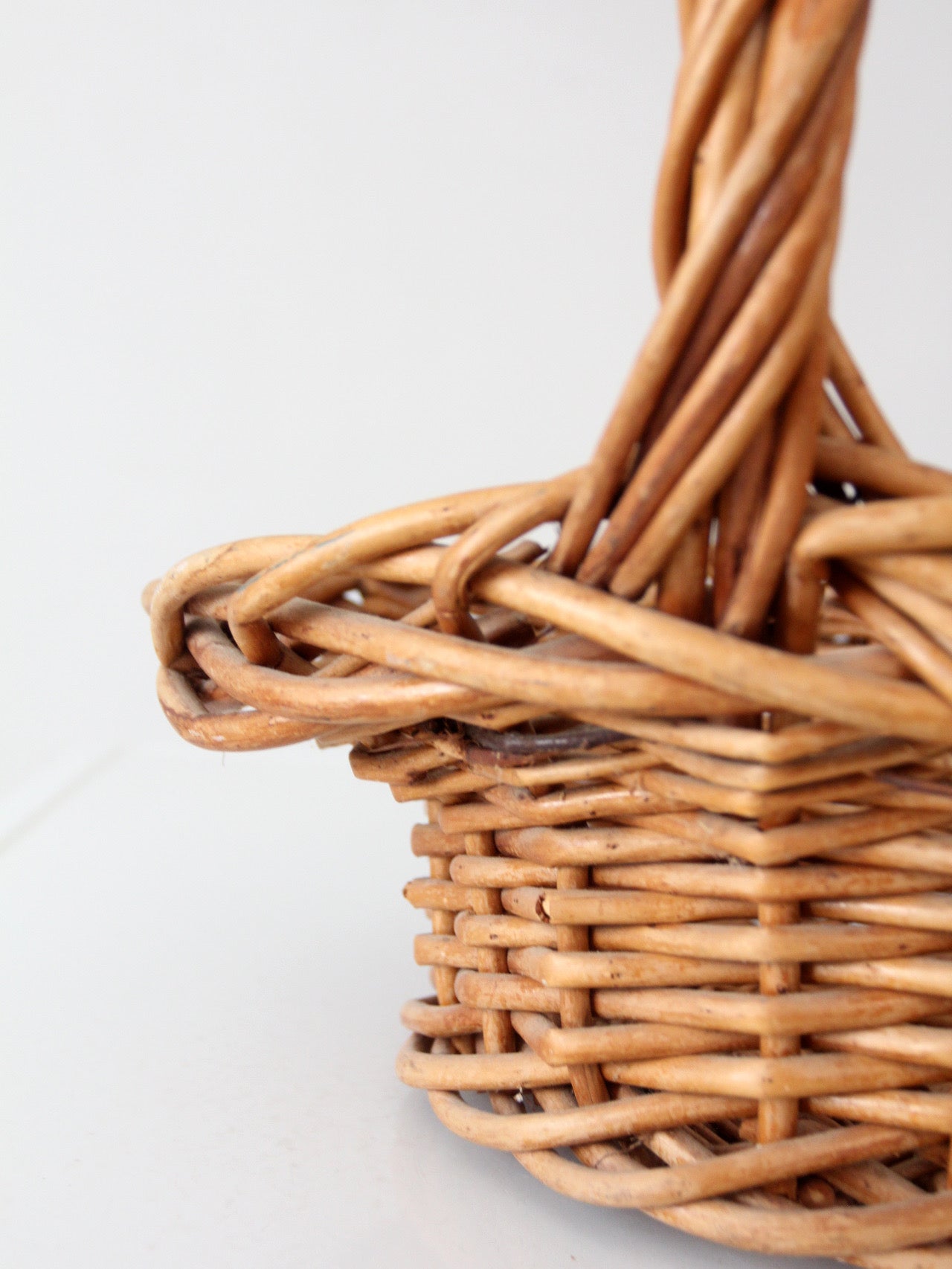 vintage woven wicker gathering basket with twisted handle