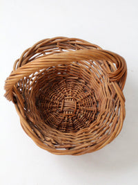 vintage woven wicker gathering basket with twisted handle