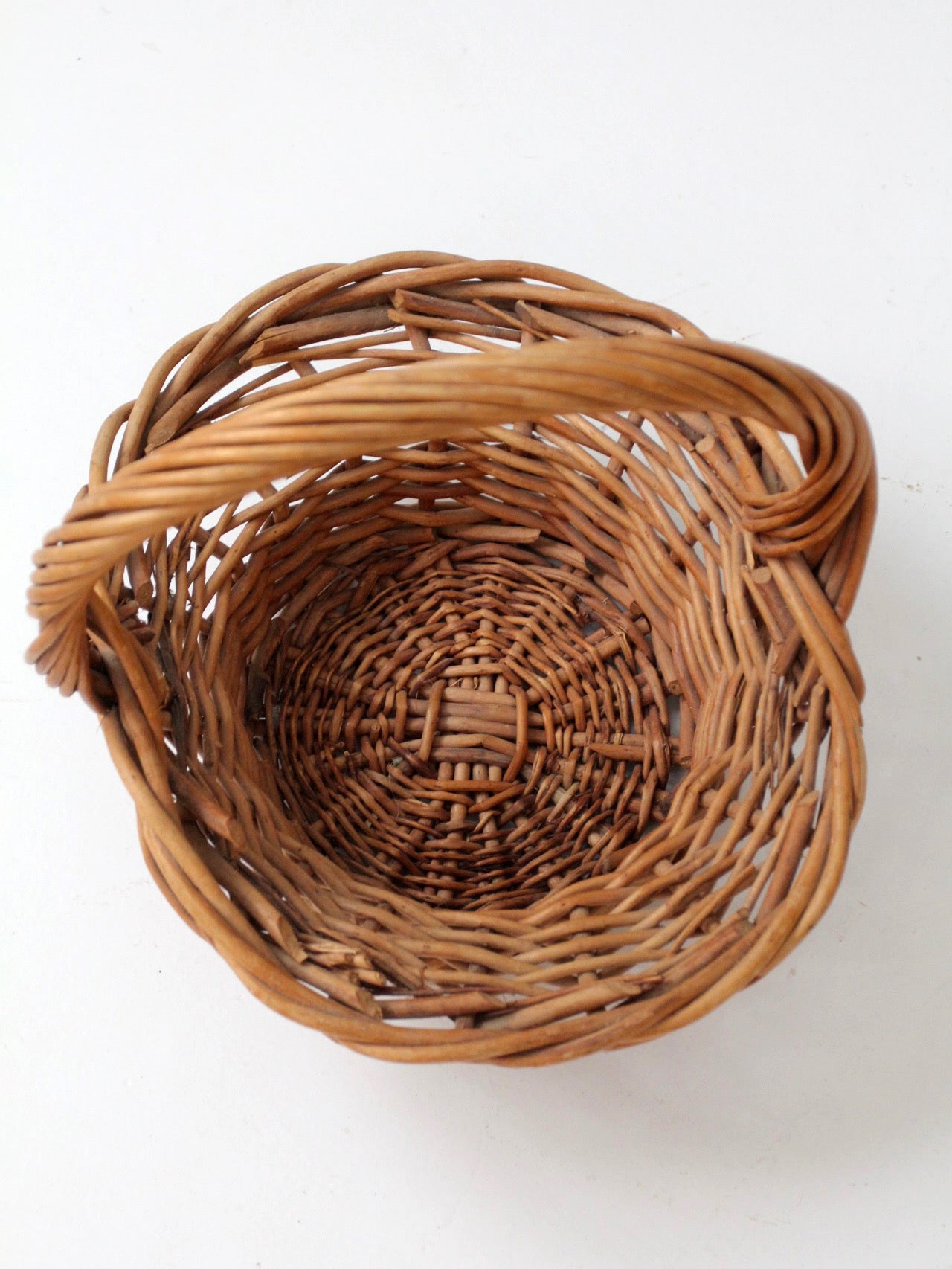 vintage woven wicker gathering basket with twisted handle