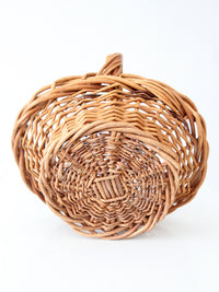 vintage woven wicker gathering basket with twisted handle
