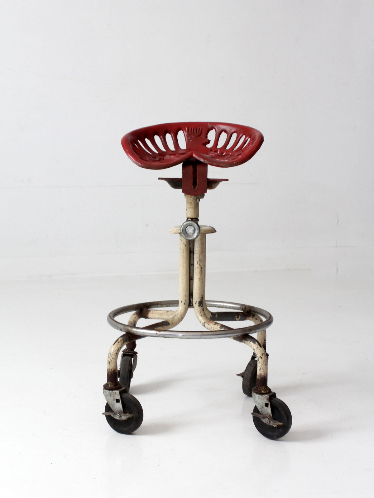 vintage industrial rolling stool with cast iron tractor seat