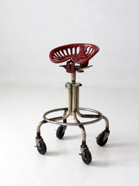vintage industrial rolling stool with cast iron tractor seat
