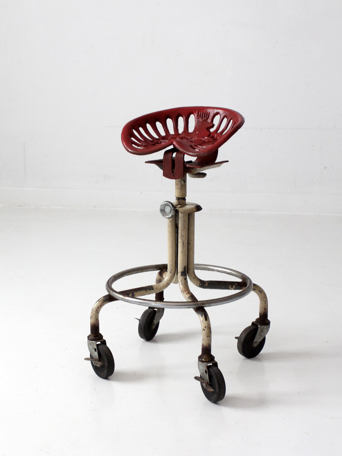 vintage industrial rolling stool with cast iron tractor seat