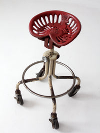 vintage industrial rolling stool with cast iron tractor seat