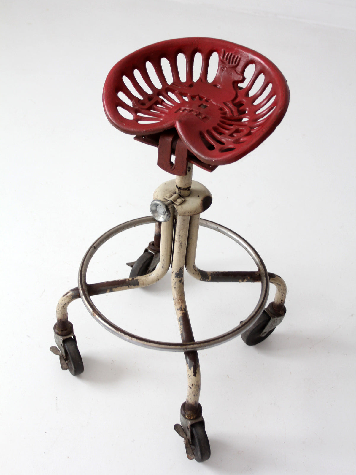 vintage industrial rolling stool with cast iron tractor seat
