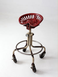 vintage industrial rolling stool with cast iron tractor seat