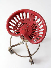 vintage industrial rolling stool with cast iron tractor seat