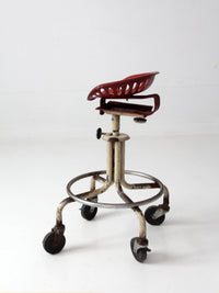vintage industrial rolling stool with cast iron tractor seat