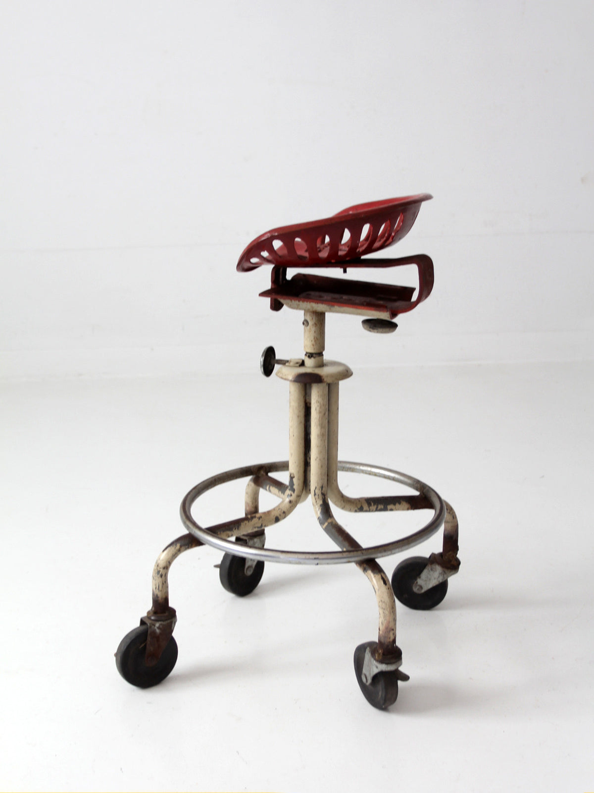 vintage industrial rolling stool with cast iron tractor seat
