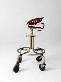 vintage industrial rolling stool with cast iron tractor seat